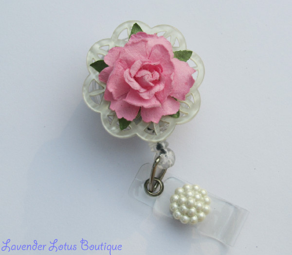 Shabby Chic Inspired Retractable Badge Reel features a pink paper rose on a  cutwork acrylic disc with a vintage inspired button on the credentials strap